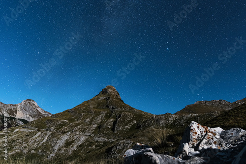 Night photography of the starry sky and mountain peaks. Aerial photography in summer