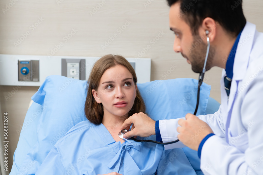 Fototapeta premium The doctor did a daily check-up and talked about the serious illness that had happened to the girl. to know the progress of treatment
