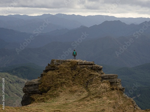Lone hiker enjoying backcountry nature landscape mountain panorama at Bell Rock lookout in Tutira Hawkes Bay New Zealand