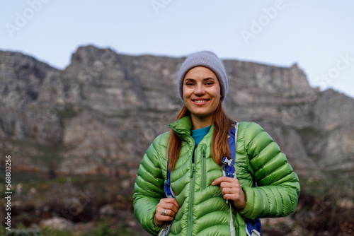 Portrait of smiling female caucasian hiker in winter clothes