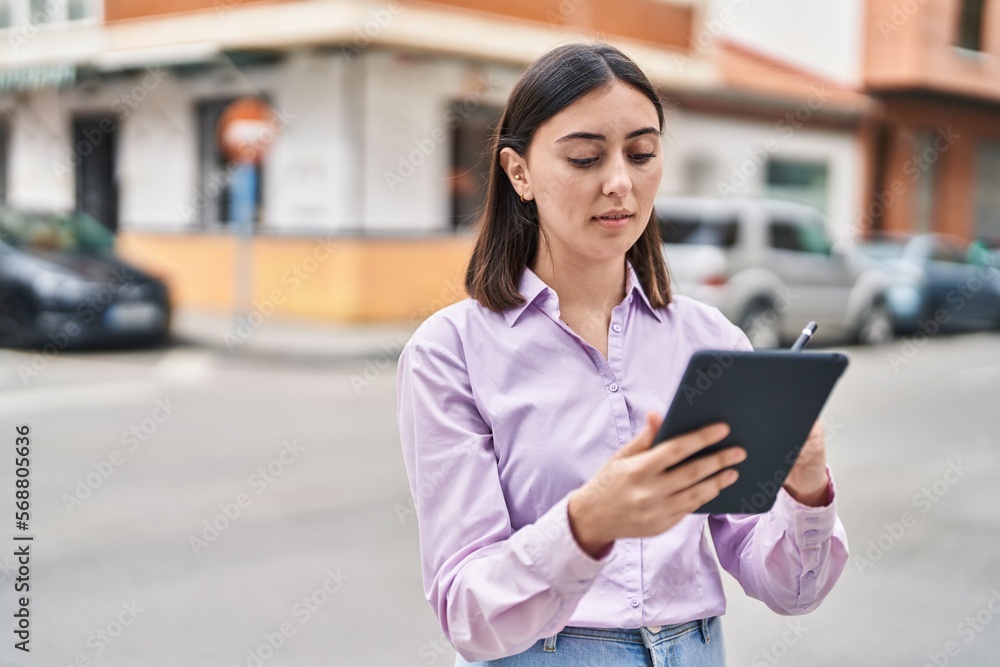 Young hispanic woman using touchpad at street Young hispanic woman using touchpad at street