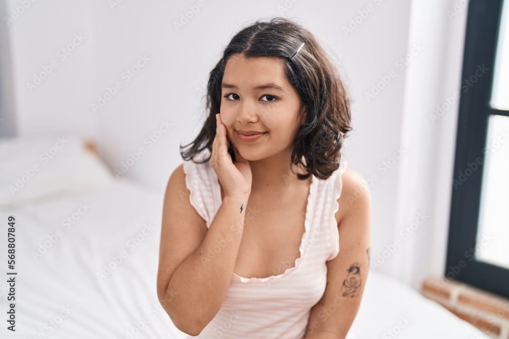 Young woman smiling confident sitting on bed at bedroom Young woman smiling confident sitting on bed at bedroom