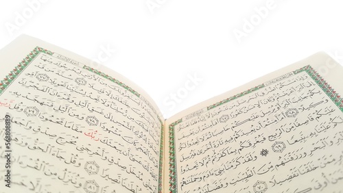 Open Quran pages with white background. Surah Al Baqarah. Arabic letters. Selective focus on letters. Al-Quran is a holy book of Islamic guidance isolated. Religion concept. photo