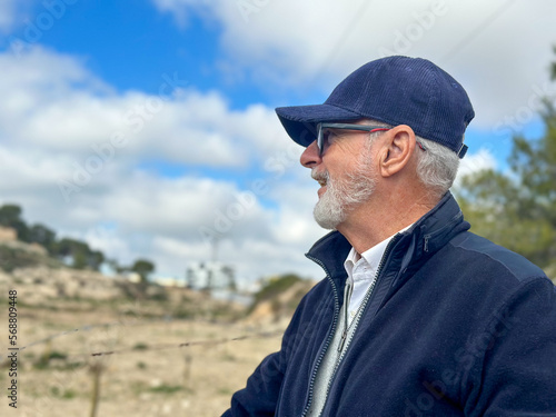 Portrait of healthy happy smile senior elderly caucasian old man grandfather in the park outdoors with copy space. Spring autumn golden age healthcare cheerful lifestyle freedom retirement concept © Danko