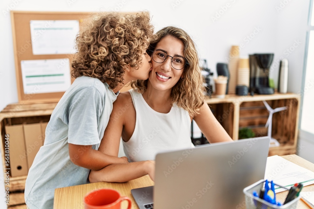 Mother and son smiling confident and hugging and kissing working at office Mother and son smiling confident and hugging and kissing working at office