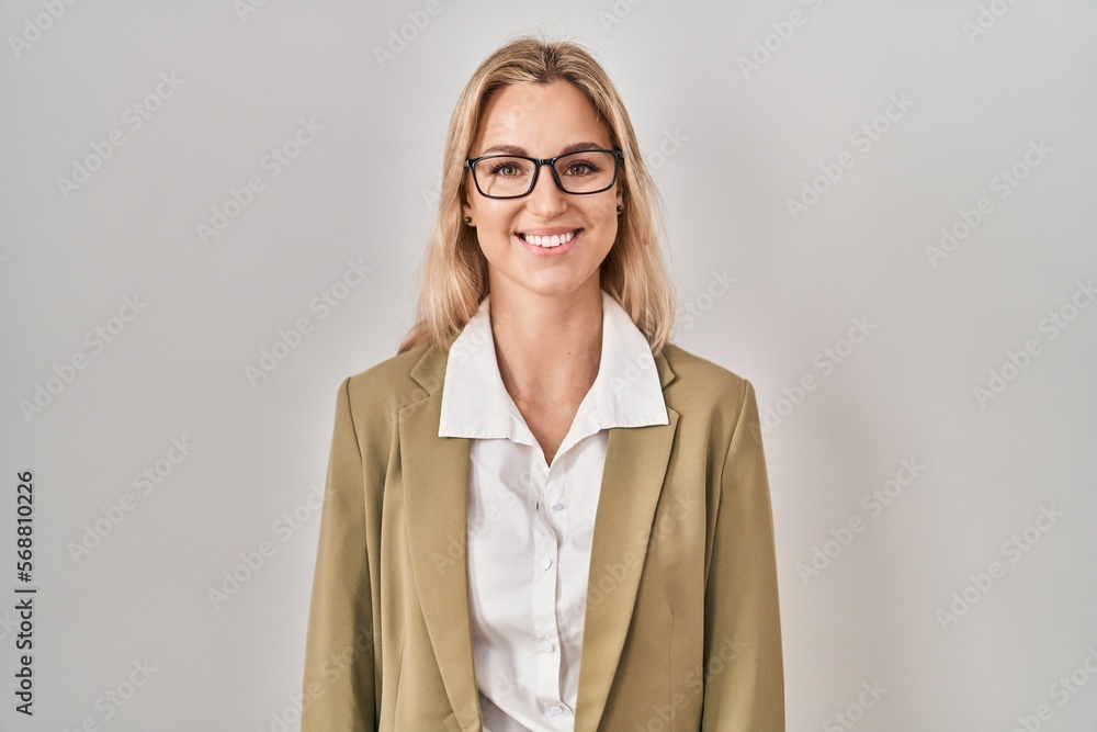 Young caucasian woman wearing glasses looking positive and happy standing and smiling with a confident smile showing teeth Young caucasian woman wearing glasses looking positive and happy standing and smiling with a confident smile showing teeth