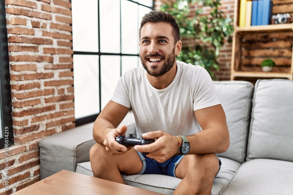 Young hispanic man smiling confident playing video game at home Young hispanic man smiling confident playing video game at home