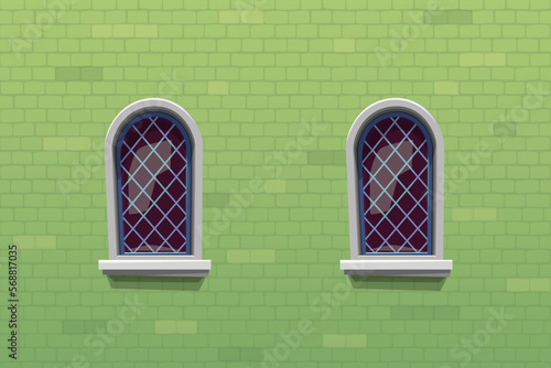 medieval windows on green color brick wall
