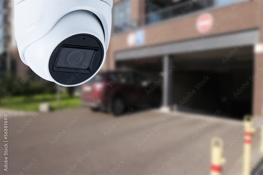 Closeup CCTV camera monitoring in the cars park. An automated car parking system. Closeup CCTV camera monitoring in the cars park. An automated car parking system.