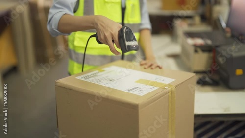 Portrait of woman worker scanning barcode in warehouse retail store industry factory. Rack of stock storage. Cargo in ecommerce and logistic concept. Depot. People lifestyle. Shipment service.