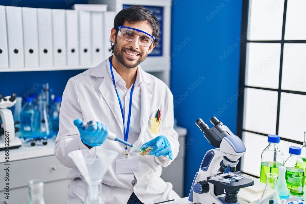 Young hispanic man scientist smiling confident working at laboratory Young hispanic man scientist smiling confident working at laboratory