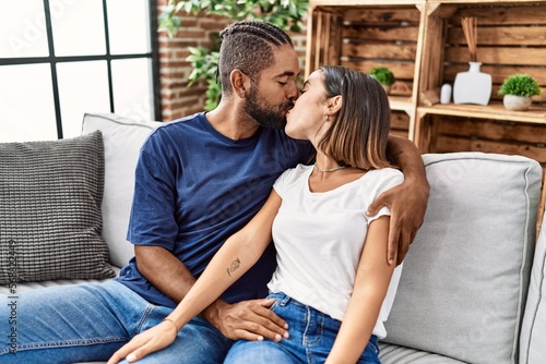 Man and woman couple kissing and hugging each other at home