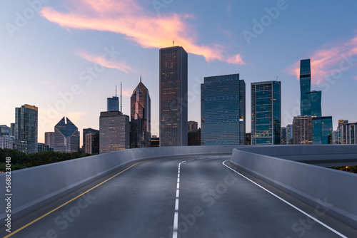 Empty urban asphalt road exterior with city buildings background. New modern highway concrete construction. Concept of way to success. Transportation logistic industry fast delivery. Chicago. USA.