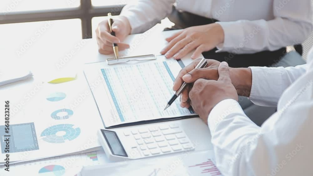 Financial analysts analyze business financial reports on a digital tablet planning investment project during a discussion at a meeting of corporate showing the results of their successful teamwork. Financial analysts analyze business financial reports on a digital tablet planning investment project during a discussion at a meeting of corporate showing the results of their successful teamwork.