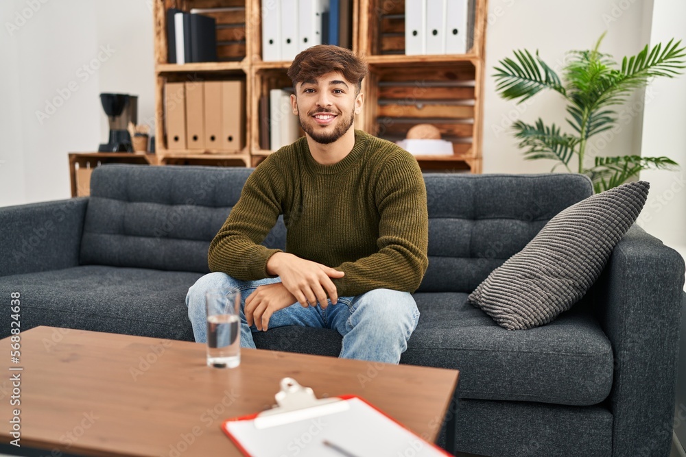 Arab man with beard working on depression at therapy office with a happy and cool smile on face. lucky person. Arab man with beard working on depression at therapy office with a happy and cool smile on face. lucky person.