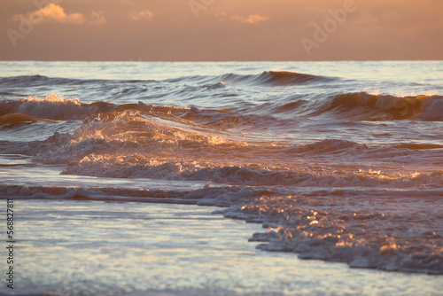 sea storm waves in sunset light