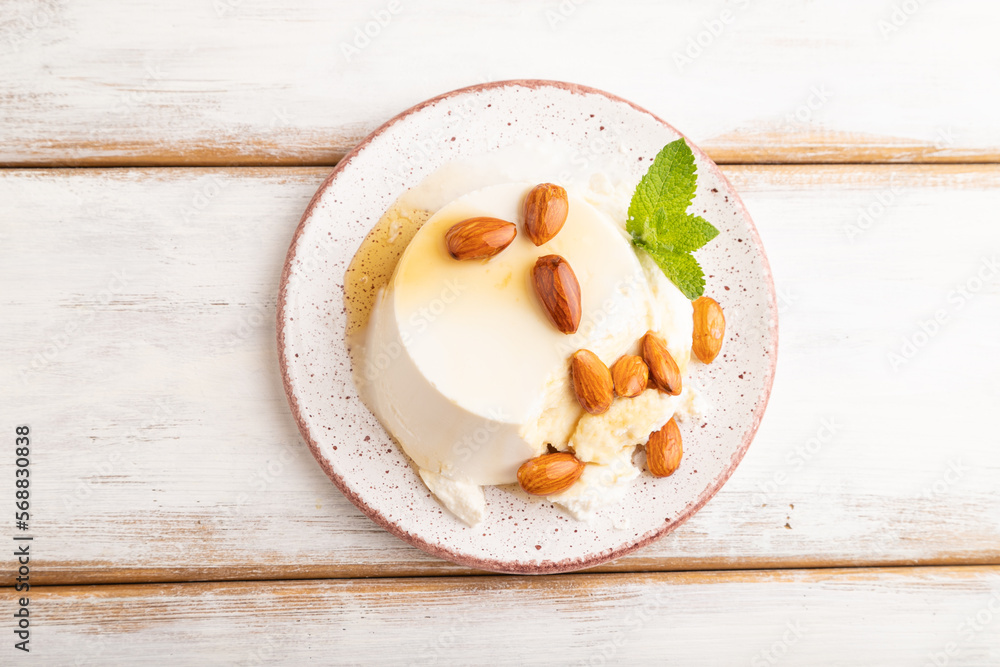 Ricotta cheese with honey and almonds on white wooden. top view, flat lay, close up. Ricotta cheese with honey and almonds on white wooden. top view, flat lay, close up.