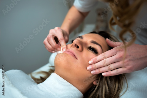 Makeup artist applay permanent makeup procedure. Lips makeup in the cosmetologist's salon.