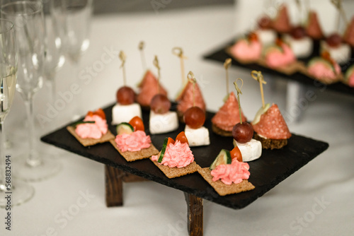 canape with caviar and seafood on a black plateau