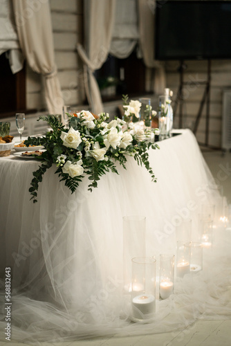 bride and groom's table decorated with candles and white flowers