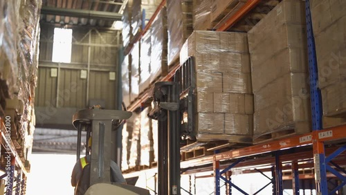 Fork lift truck with pallet car vehicle working of large warehouse retail store industry. Rack of furniture and stock storage. Interior of cargo in ecommerce and logistic concept. Depot transportation