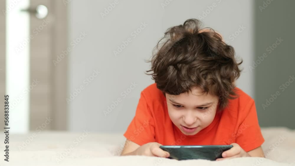 primary school boy feeling angry as she lost game and has to start all over again. Mad female child having displeased look because of low battery on cell phone. primary school boy feeling angry as she lost game and has to start all over again. Mad female child having displeased look because of low battery on cell phone.