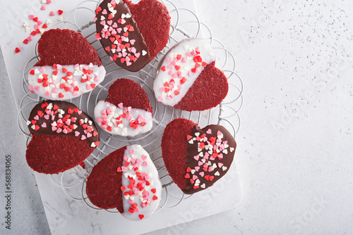 Valentines Day. Red velvet or brownie cookies on heart shaped in chocolate icing on a pink romantic background. Dessert idea for Valentines Day, Mothers or Womens Day. Tasty homemade dessert cake