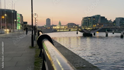 Custom House quay, Dublin Sean o'Casey bridge action at dusk, liffey river, view from the quays, horizontal. photo