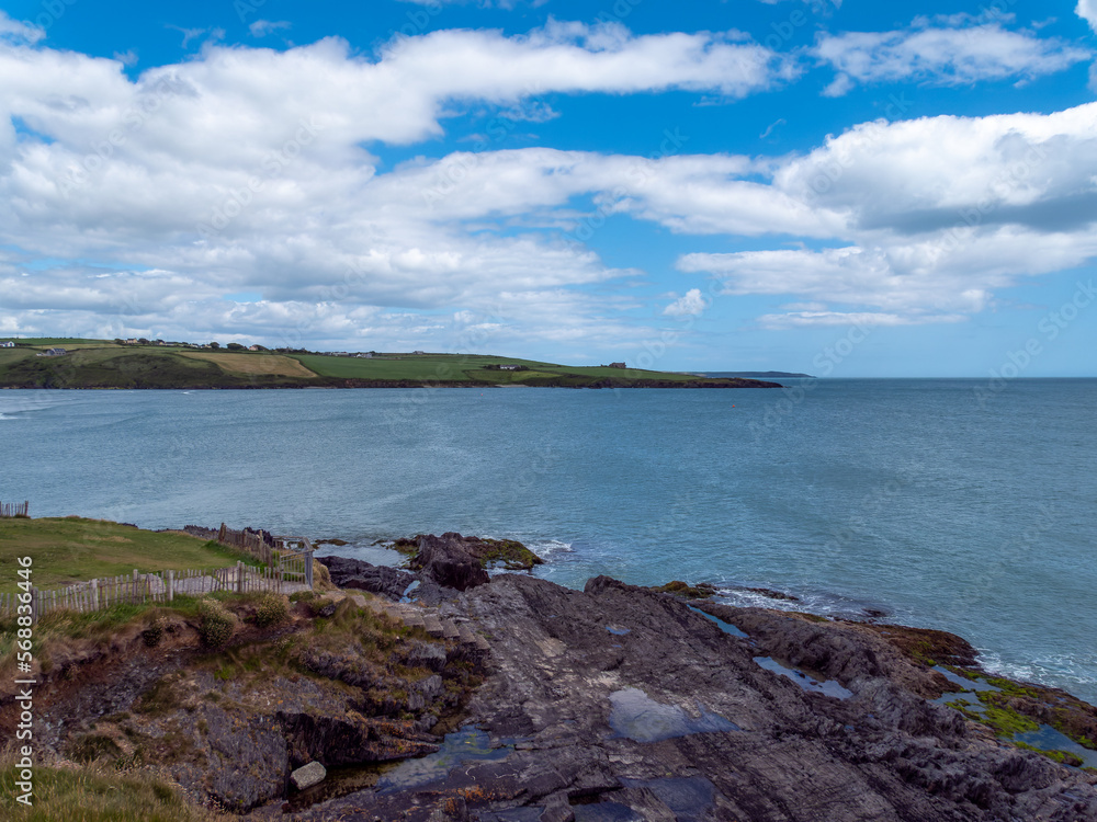 Clonakilty Bay under a beautiful cloudy sky on a summer day. Irish seascape, body of water under blue sky.
