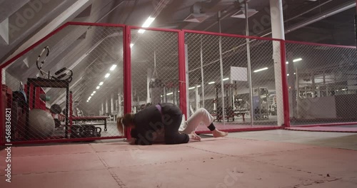 Woman performing takedown and chokehold on Muslim opponent