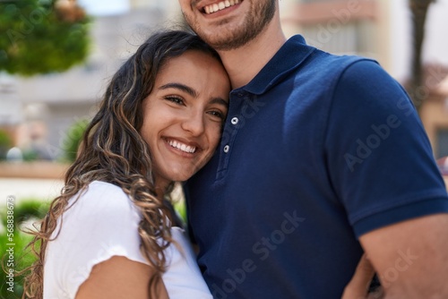 Young hispanic couple smiling confident hugging each other at park © Krakenimages.com