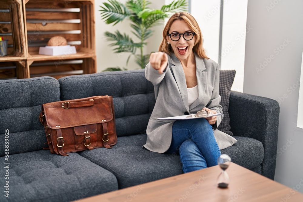 Hispanic woman working at consultation office pointing to you and the camera with fingers, smiling positive and cheerful Hispanic woman working at consultation office pointing to you and the camera with fingers, smiling positive and cheerful