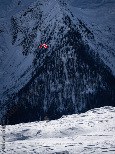 paragliding in snow covered mountains