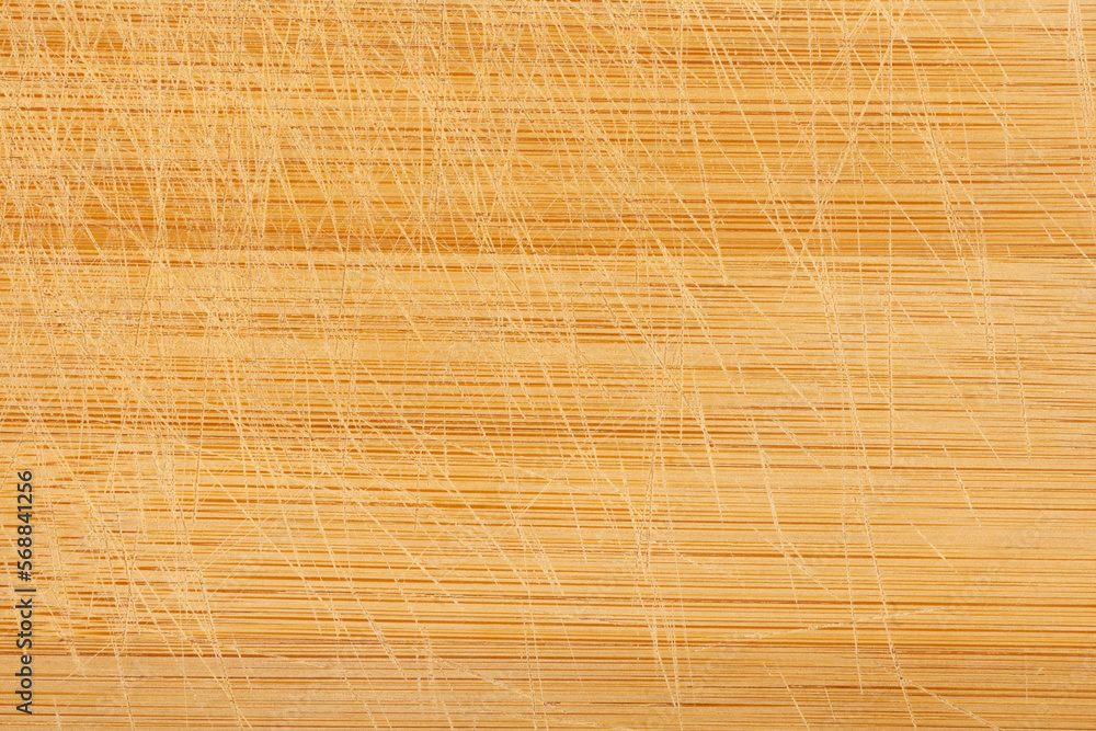 Wooden chopping board with visible knife cuts. Wooden chopping board with visible knife cuts.