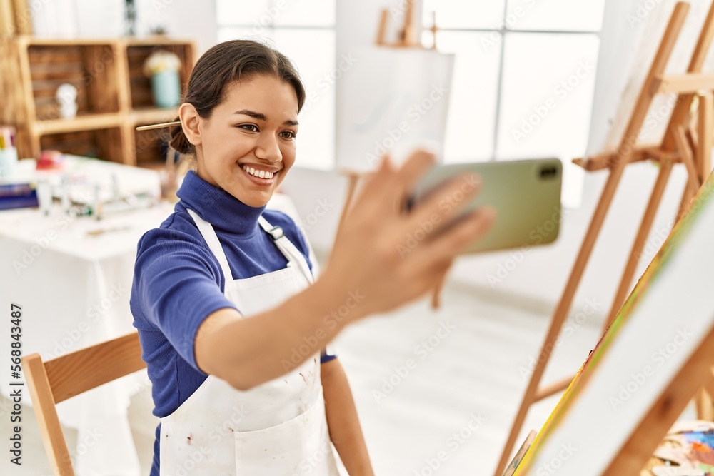 Young latin woman smiling confident make selfie by the smartphone at art studio Young latin woman smiling confident make selfie by the smartphone at art studio