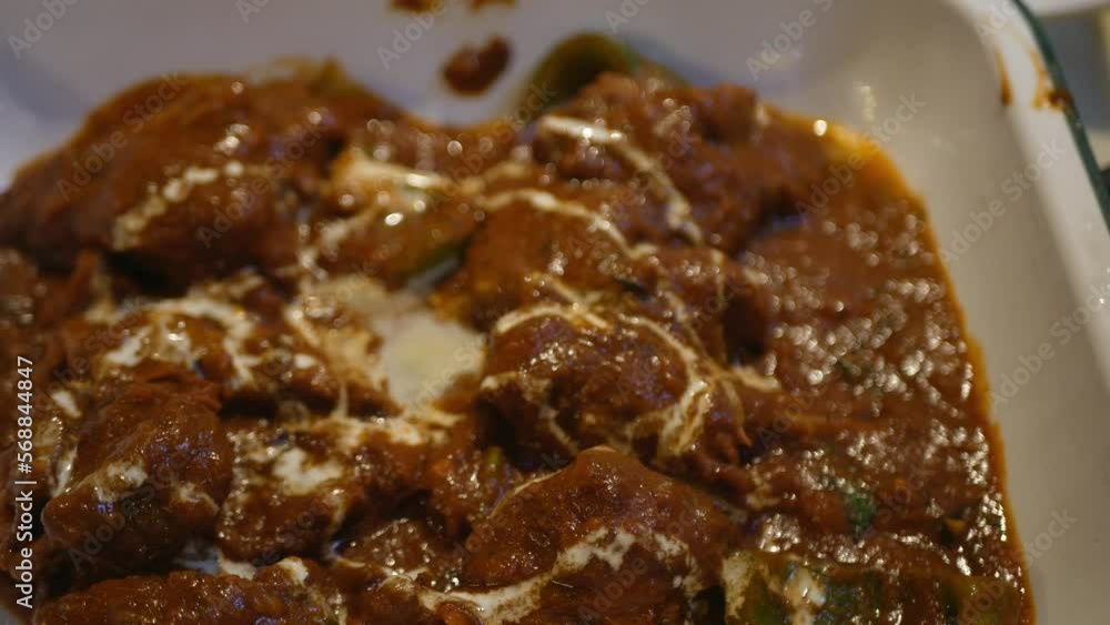 close up to the red chicken butter curry indian food Chicken Masala asian traditional masala gravy meal with vegetables and white sauce close up to the red chicken butter curry indian food Chicken Masala asian traditional masala gravy meal with vegetables and white sauce