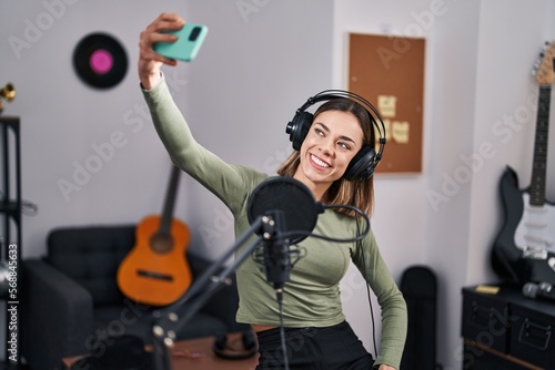 Young beautiful hispanic woman musician smiling confident make selfie by smartphone at music studio