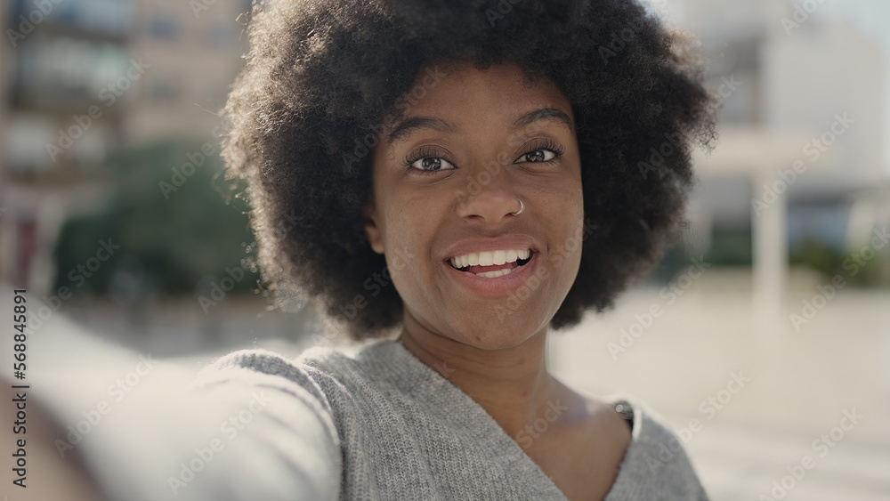Fototapeta premium African american woman smiling confident making selfie by camera at street