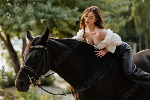 Beautiful girl in leather pants on horseback