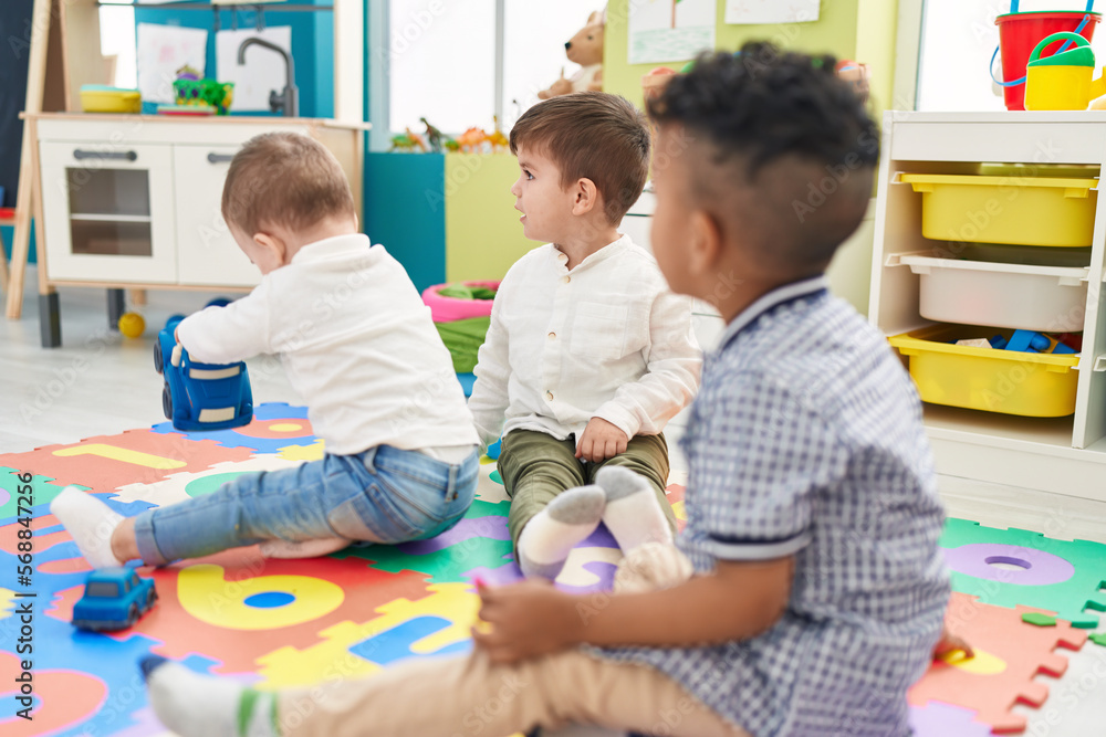 Group of kids playing with cars toys sitting on floor at kindergarten Group of kids playing with cars toys sitting on floor at kindergarten