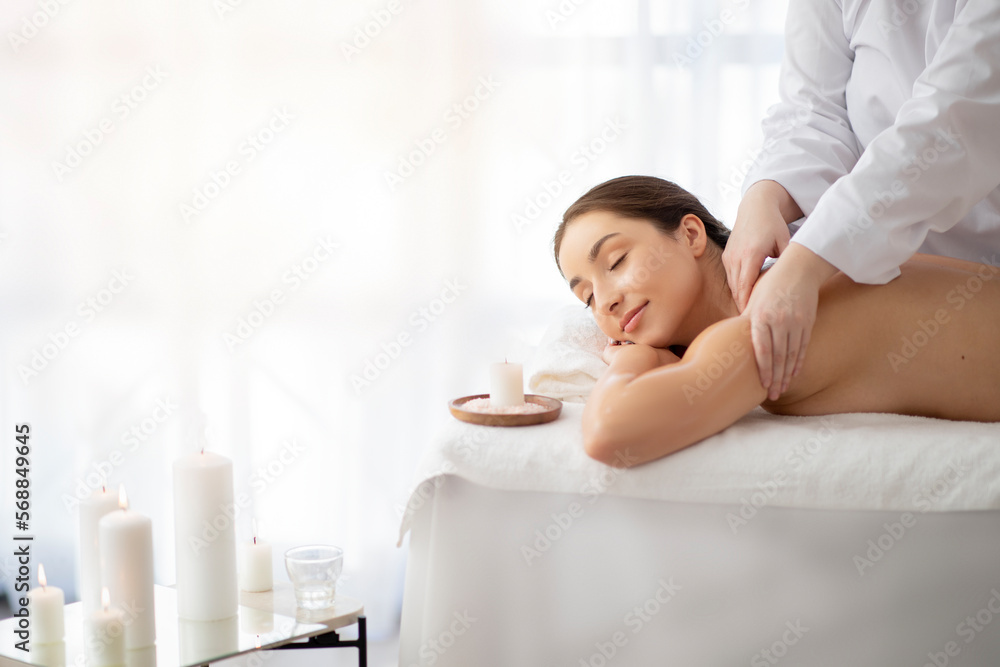 Spa Day. Beautiful Indian Woman Enjoying Relaxing Massage In Salon Spa Day. Beautiful Indian Woman Enjoying Relaxing Massage In Salon