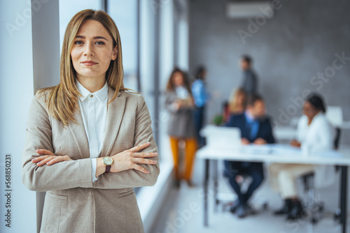 Portrait of a confident mature businesswoman working in a modern office. Cropped portrait of an attractive young businesswoman standing in her office with her arms folded during the day © Dragana Gordic