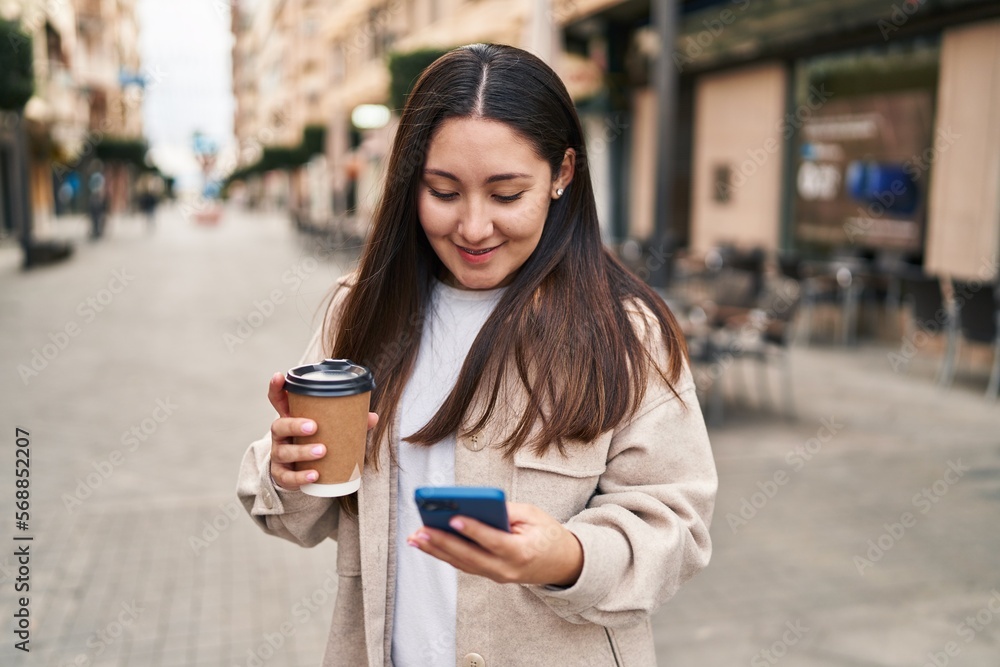 Young hispanic woman using smartphone drinking coffee at street Young hispanic woman using smartphone drinking coffee at street