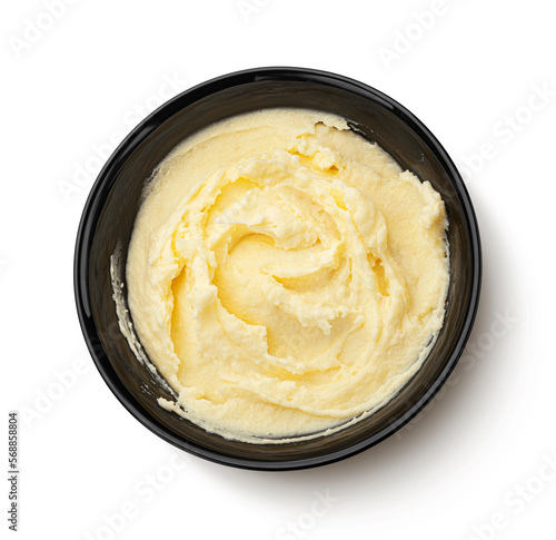 Fotografie Mashed potato in black bowl isolated on white background, top view