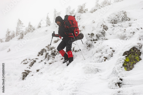 A man descends a slope on a winter hike