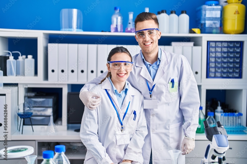 Man and woman scientists smiling confident hugging each other at laboratory Man and woman scientists smiling confident hugging each other at laboratory