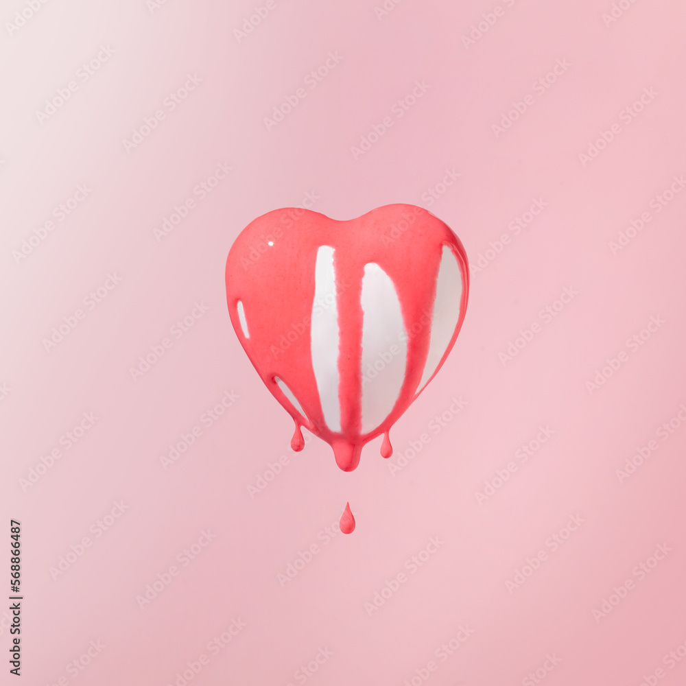 Minimal composition with levitating white heart and pink liquid paint. Love is in the air concept.