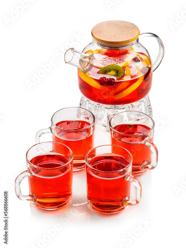 Red fruit tea with oranges, kiwi, strawberries in a glass teapot and cups. On a white background , isolate