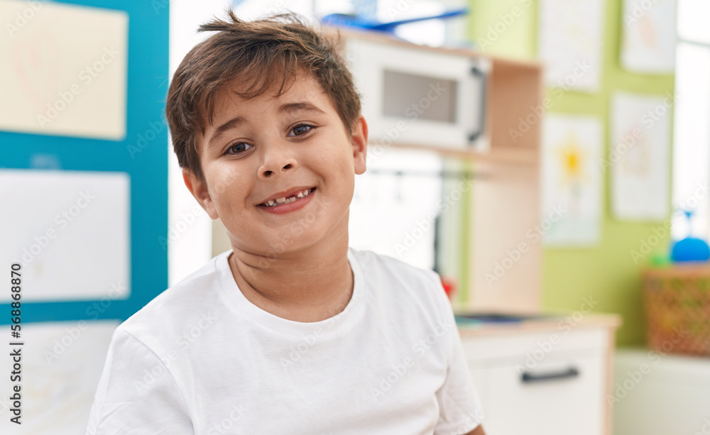 Adorable hispanic boy smiling confident standing at kindergarten Adorable hispanic boy smiling confident standing at kindergarten