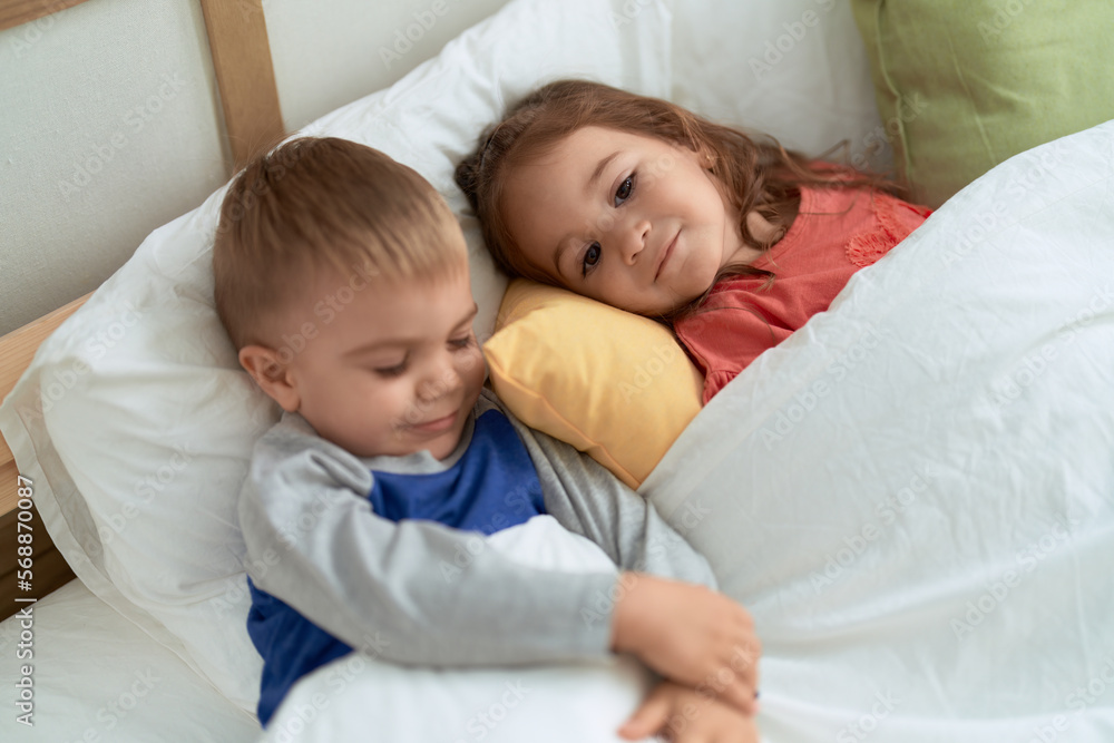 Adorable girl and boy smiling confident lying on bed at bedroom Adorable girl and boy smiling confident lying on bed at bedroom